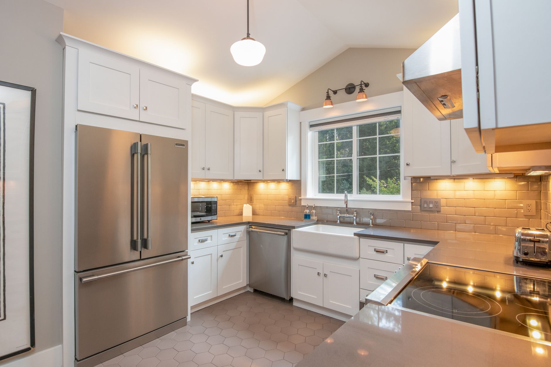 Bright and sleek modern kitchen featuring stainless steel appliances and white cabinetry in Palm Springs, CA